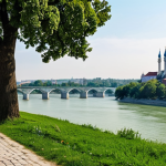 **

"Scenic view of Belgrade's Kalemegdan Park, showcasing the confluence of the Sava and Danube rivers. Ancient fortress walls and towers are visible. A fully clothed family strolls through the park in modest attire. Safe for work, appropriate content, perfect anatomy, natural proportions, professional photography, high quality, family-friendly."

**
